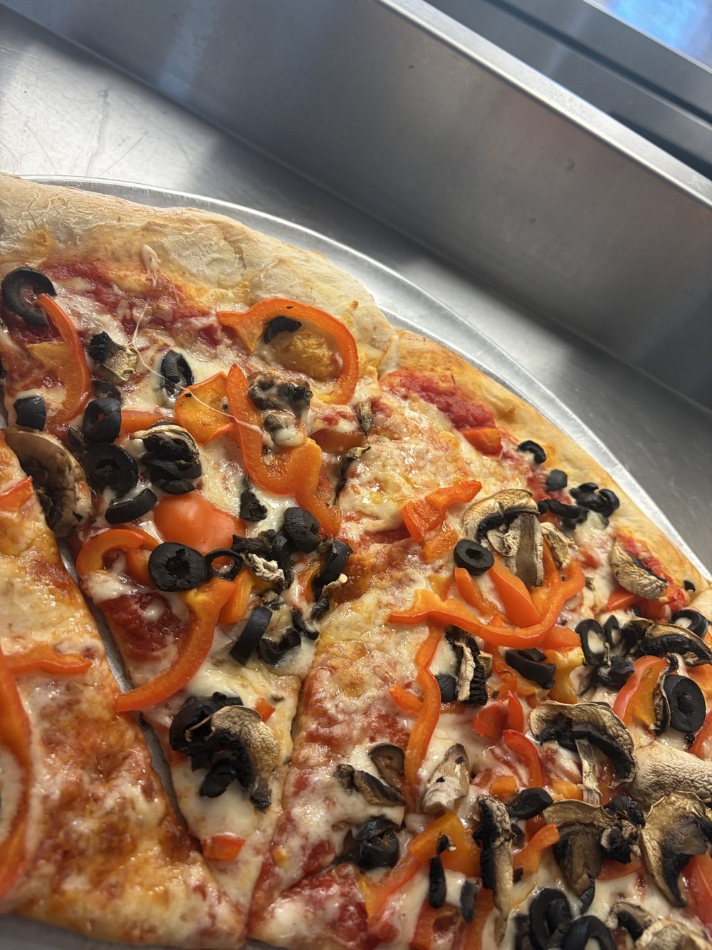 Vegan and veggie pizza with peppers, mushrooms, and black olives at Cinelli's in Greece, NY