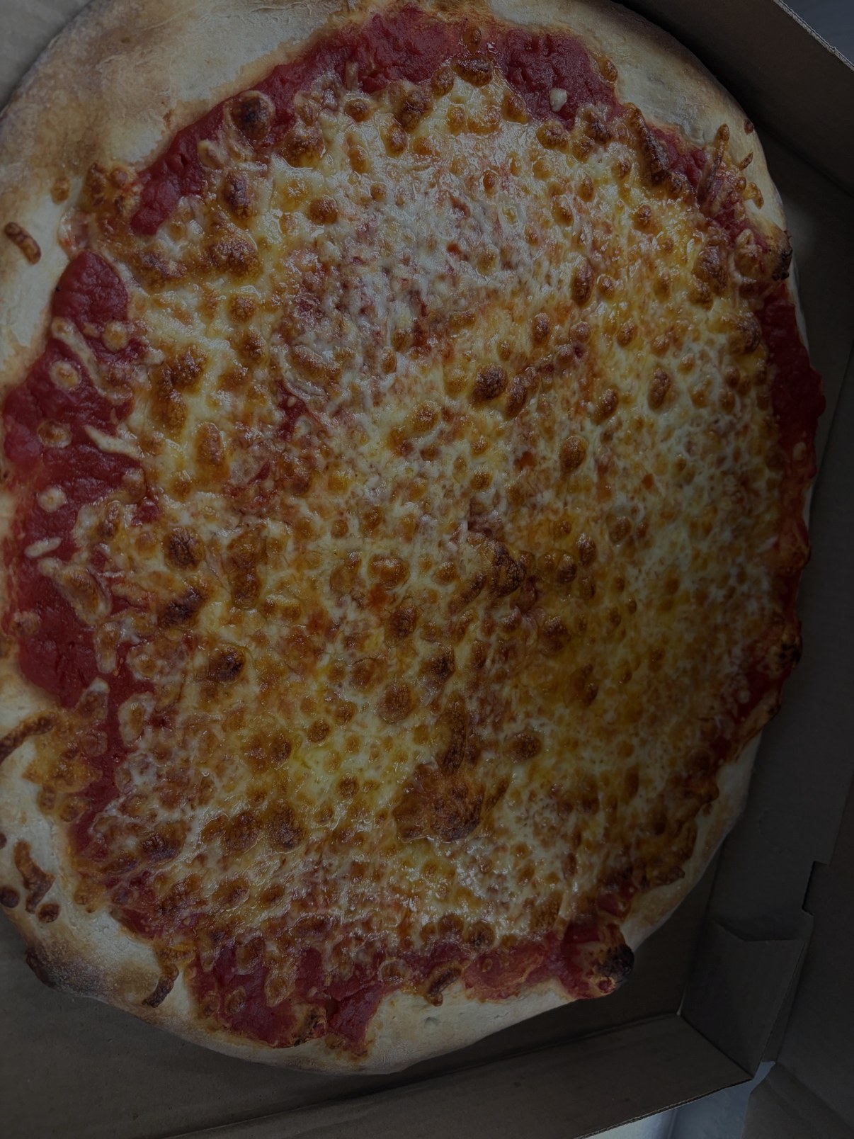 Fresh NY style cheese pizza from Cinelli's Pizza & Italian Kitchen, an Italian restaurant in Greece, NY